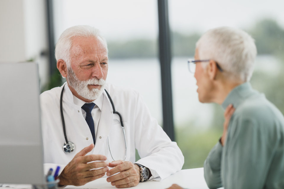 A provider meeting with a patient at a clinic desk